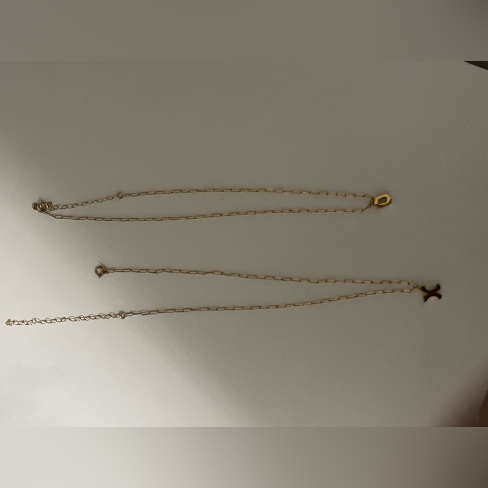 Gold played X and O necklaces.